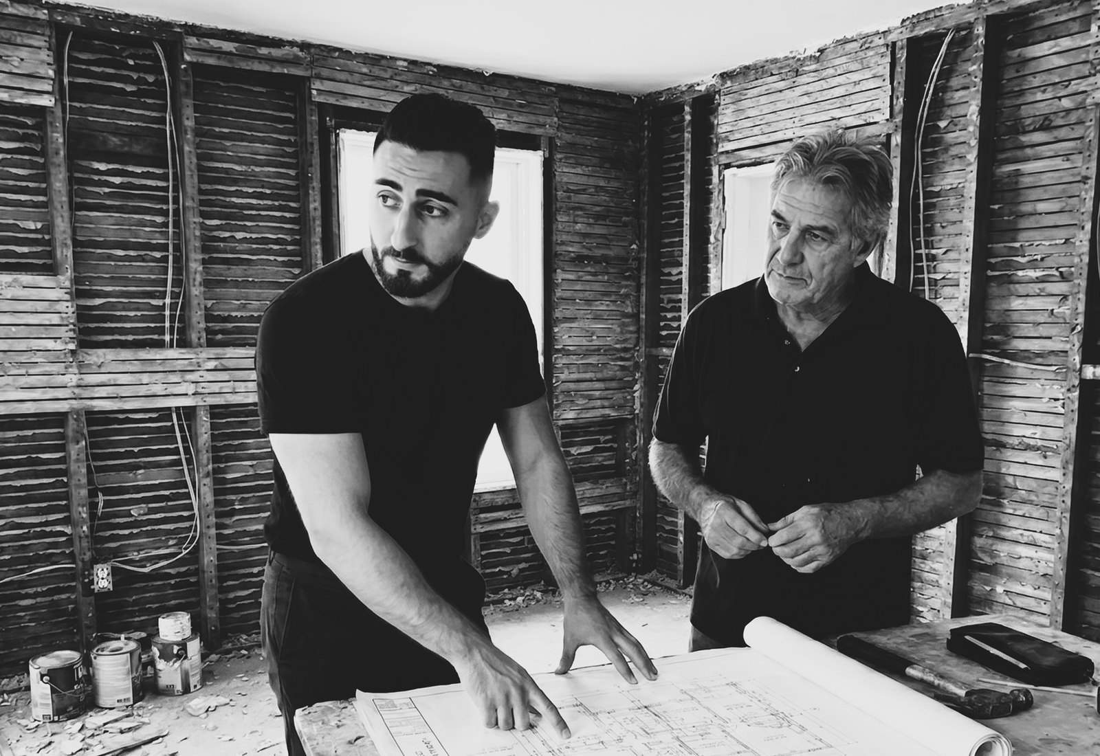 The Nobu Holdings team reviewing renovation plans on a job site